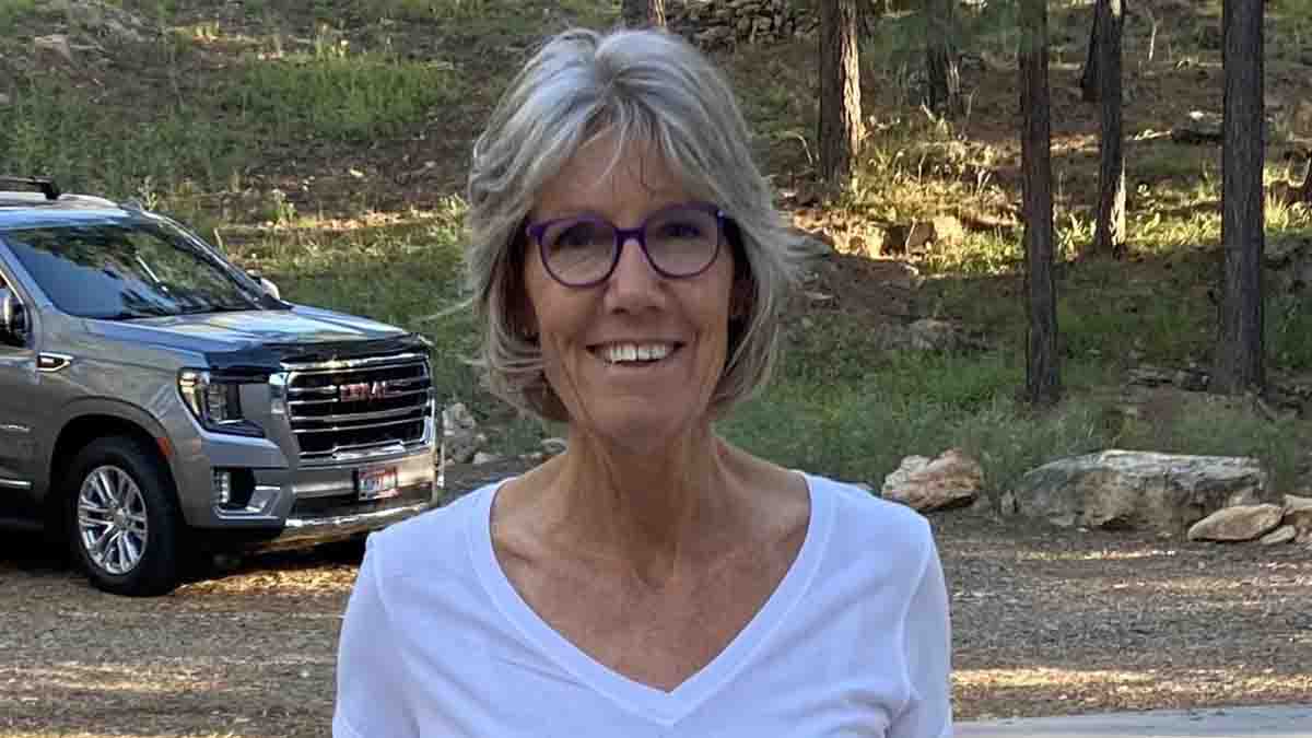 A portrait of a woman in the woods.