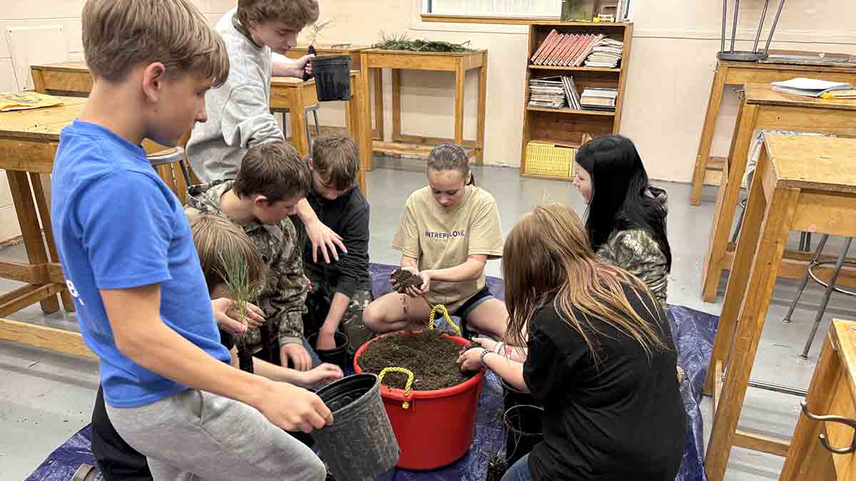 Children playing with soil in a classroom.