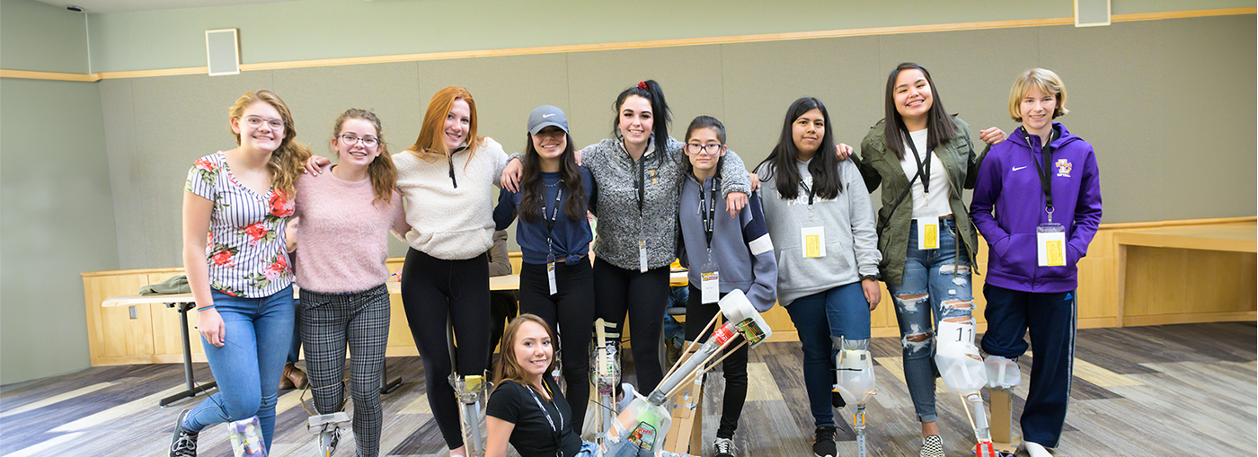 Girls demonstrating their projects during Women in Engineering day.