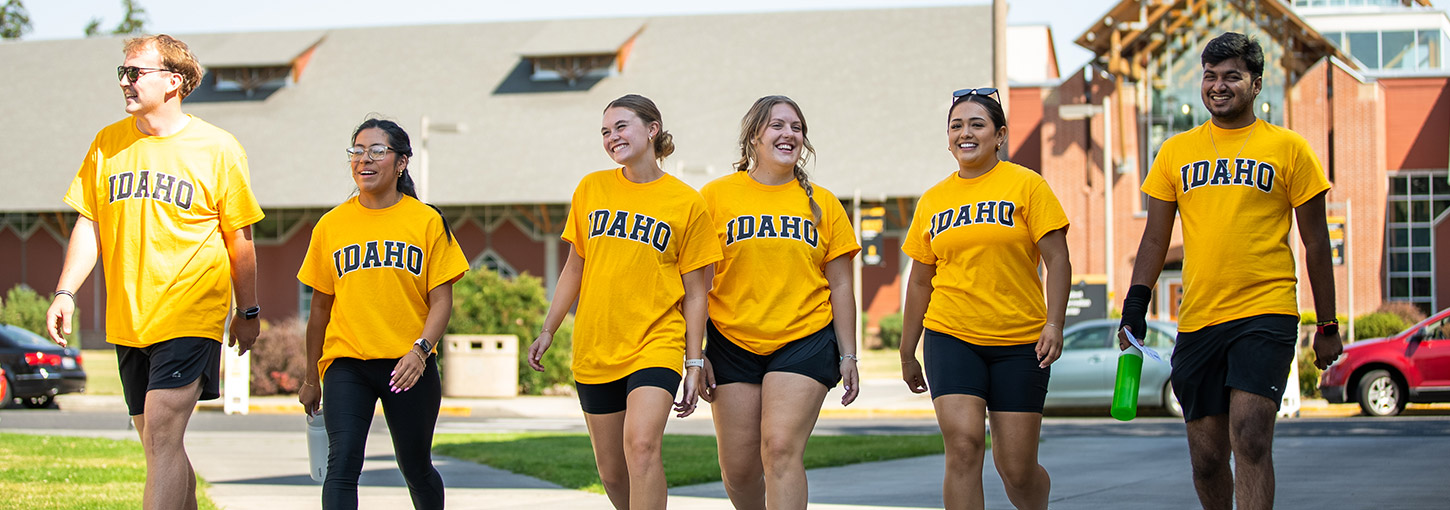 A group of U of I students wearing "Idaho" shirts while walking beside each other