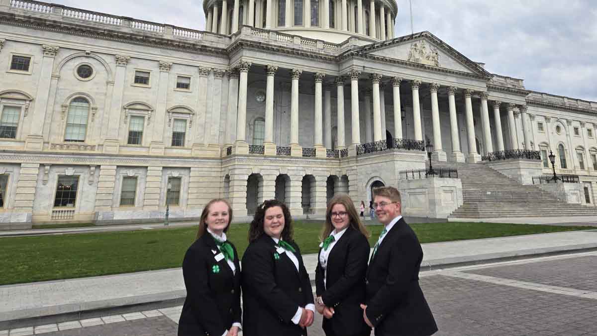 A group photo of folks with the capitol building in the background.