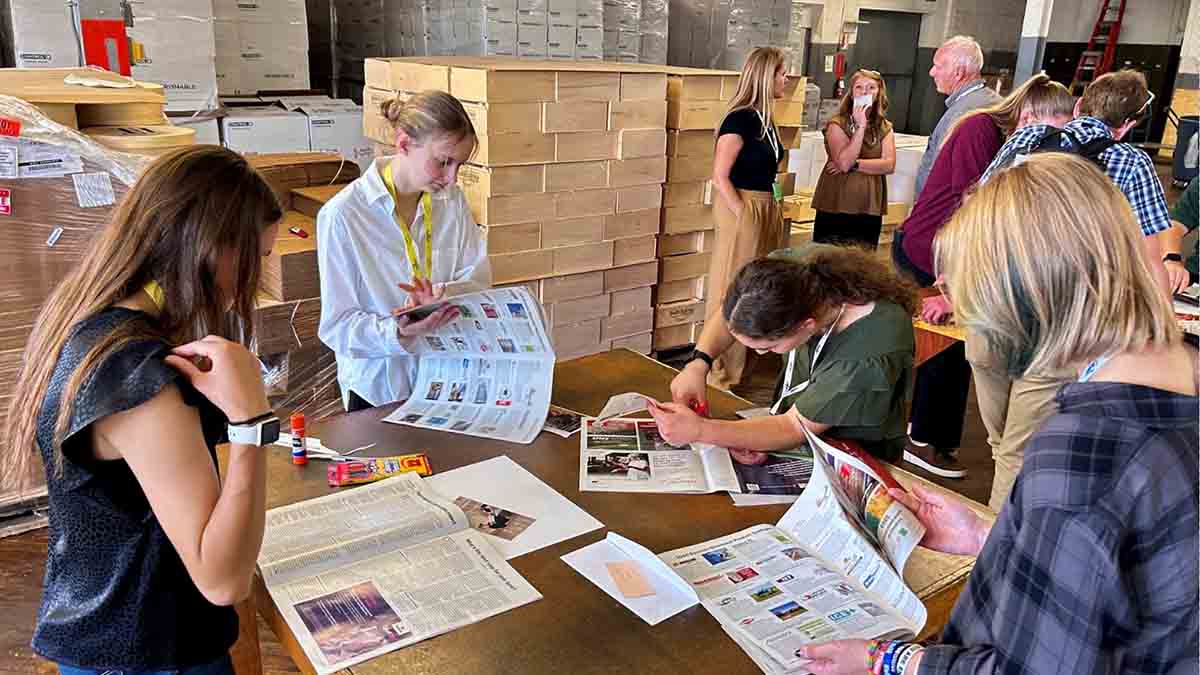 A group of women looking at magazines.