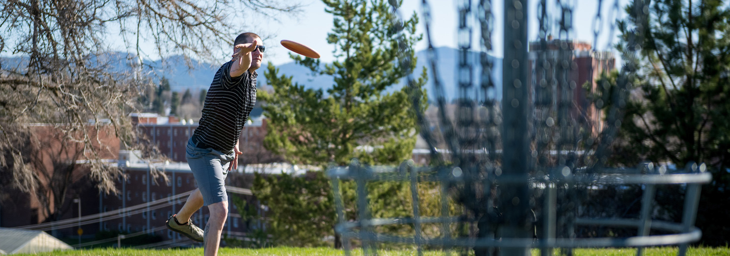 Pro disc golfer Trevor Pumnea throws a disc off a tee at the University of Idaho course in Moscow.