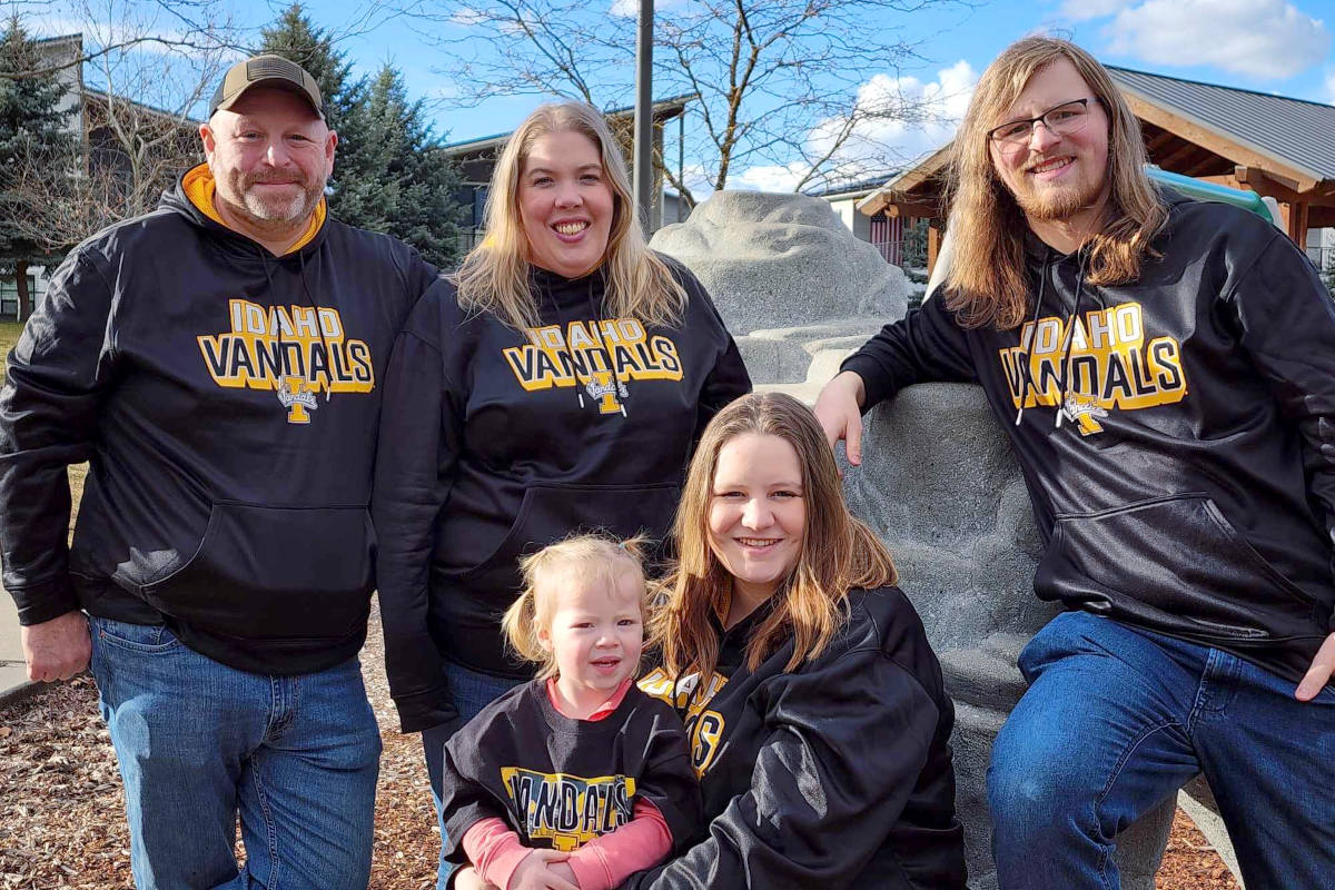 Four adults and one child wearing Vandal gear outdoors.