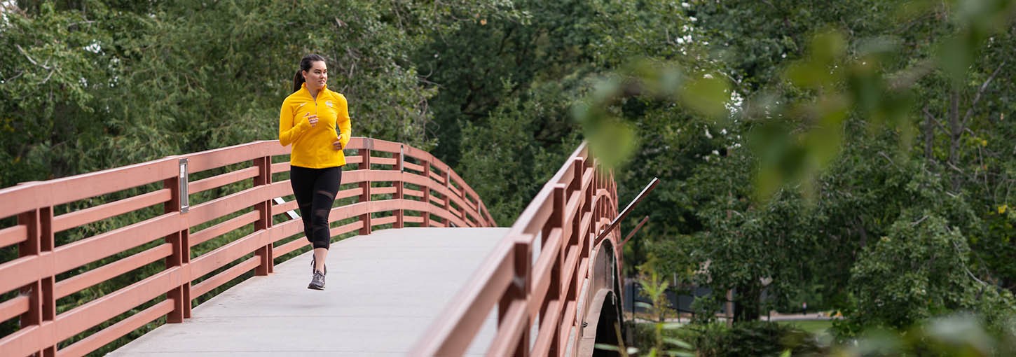 Woman running on a bridge